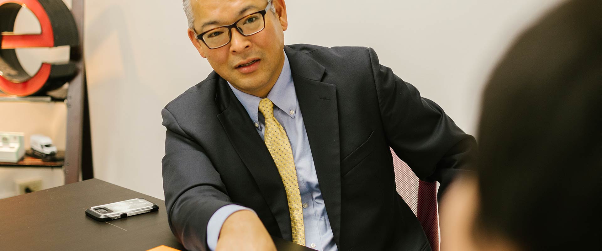 Man in Suit sitting at Table